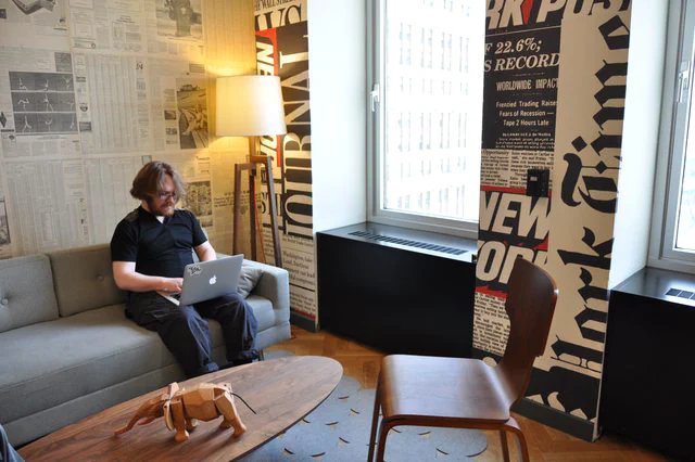 Lounge area with newspaper wallpaper