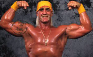 Hulk Hogan flexing his muscles while wearing a yellow bandana and wristbands