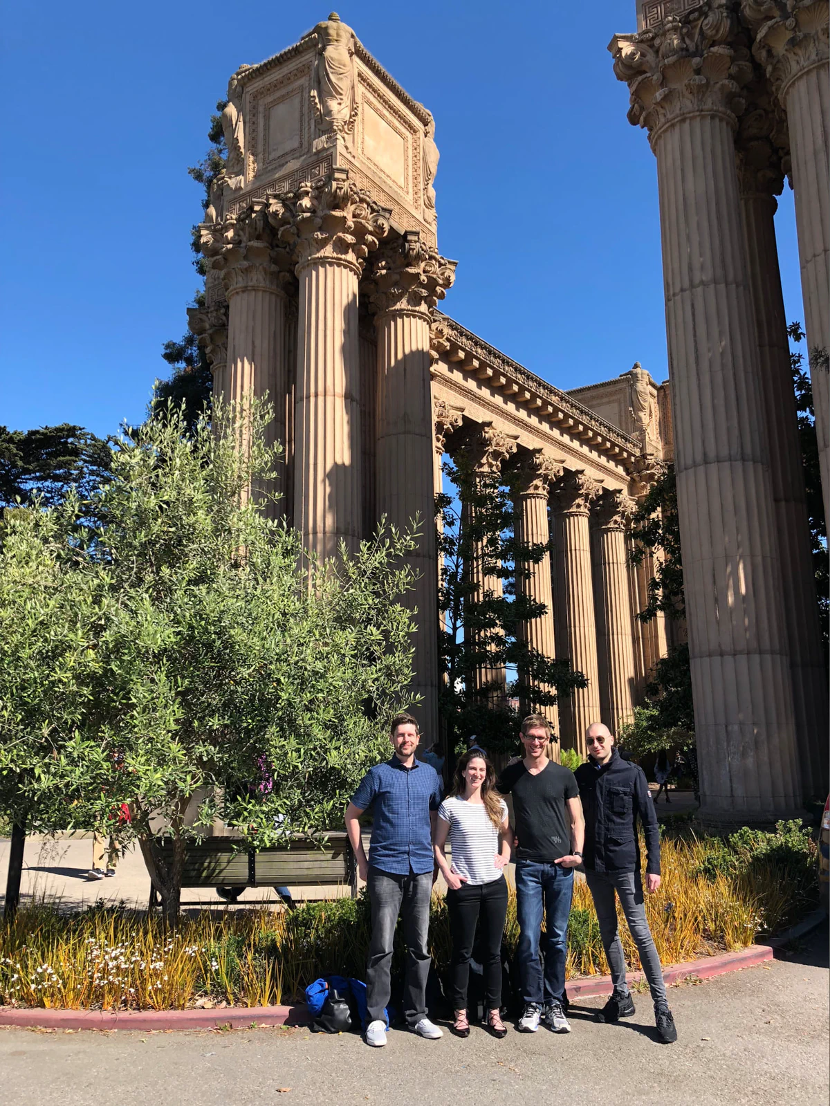 Four Trail of Bits team members standing in front of the Palace of Fine Arts in San Francisco