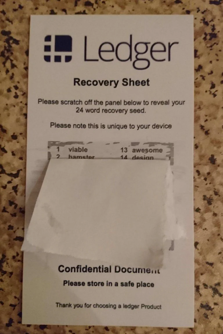 Counterfeit Ledger recovery sheet with a pre-printed 24-word recovery seed under a scratch-off panel