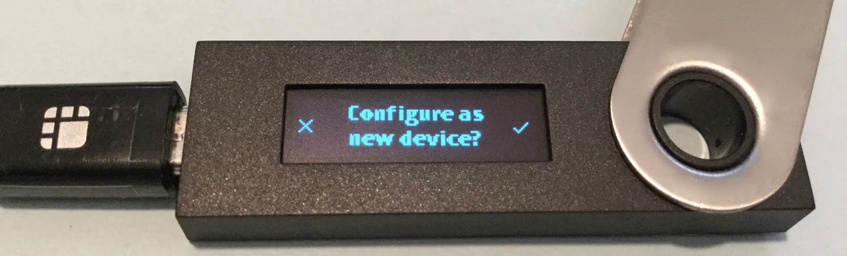 Ledger Nano S screen displaying a &ldquo;Configure as new device?&rdquo; prompt