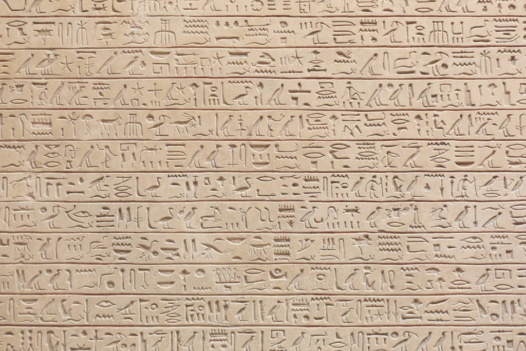 Egyptian hieroglyphics carved into a stone wall